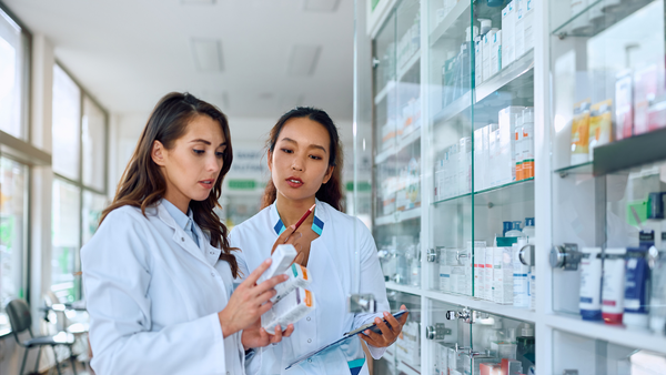 two female doctors examining medication-1